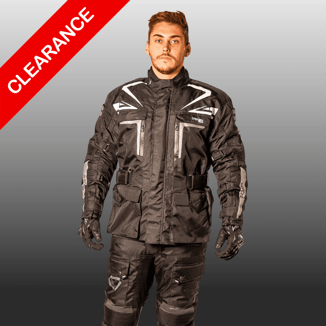 Person wearing black motorcycle gear with a clearance banner in the corner.